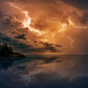 What phenomenon causes lightning and thunder in thunderstorms?