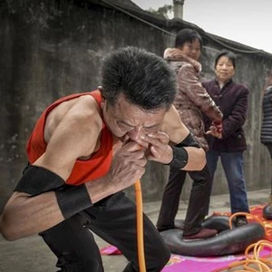 In pictures: Chinese man inflating car tires with his nose