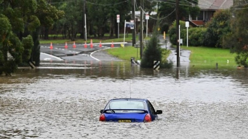 Floods in Australia inundate roads and force thousands from their homes