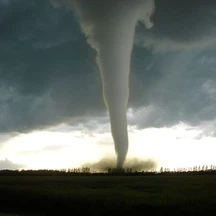 What meteorological phenomenon is a violently destructive, localized windstorm with a funnel-shaped cloud?