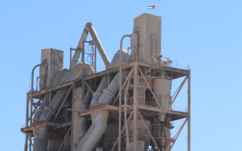 The flag of Jordan is raised over the cement factory in Al-Rashadiya to celebrate the Flag Day