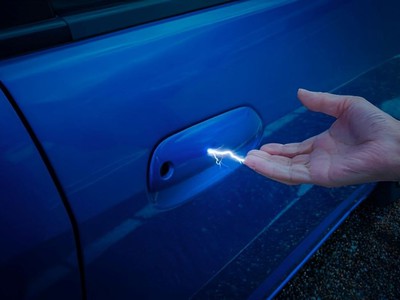 What are the causes of `electrification` when touching objects during easterly winds?