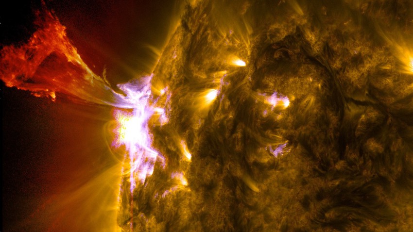 A massive solar flare sends a storm of charged particles toward Earth