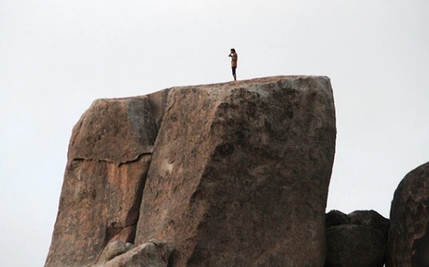 بالصور: شاب يؤدي الصلاة على قمة جبل الردف